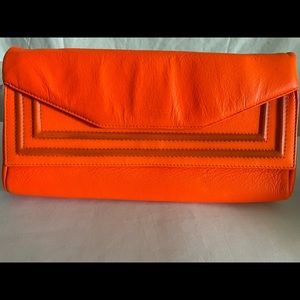 Clutch hand purse. Color:Orange. Very mild stain you can really tell.
